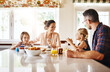 © C S W/peopleimages.com - Sharing stories at the breakfast table. Cropped shot of a family enjoying breakfast together.