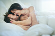© AS/peopleimages.com - Can I give you a massage. Shot of an affectionate couple lying on their bed.
