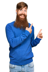 Poster - Young irish redhead man wearing casual clothes smiling and looking at the camera pointing with two hands and fingers to the side.