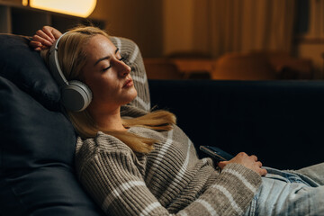 Wall Mural - Woman is peacefully resiting on the sofa at home