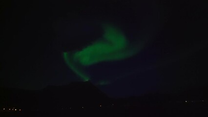 Wall Mural - Lockdown Shot Of Green Northern Lights In Dark Sky At Night - Tromso, Norway