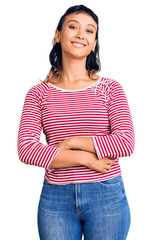 Canvas Print - Young woman wearing casual clothes looking positive and happy standing and smiling with a confident smile showing teeth