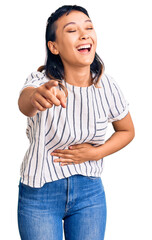 Canvas Print - Young woman wearing casual clothes laughing at you, pointing finger to the camera with hand over body, shame expression