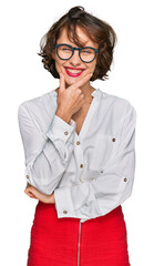 Sticker - Young hispanic woman wearing business style and glasses looking confident at the camera smiling with crossed arms and hand raised on chin. thinking positive.