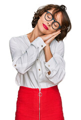 Sticker - Young hispanic woman wearing business style and glasses sleeping tired dreaming and posing with hands together while smiling with closed eyes.