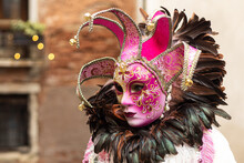 Venice, Veneto, Italy - Feb 19, 2023: Masquerade Lady In A White And Pink Costume During 2023 Venice Carnival Celebrations