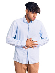 Sticker - Young hispanic man wearing casual shirt with hand on stomach because indigestion, painful illness feeling unwell. ache concept.