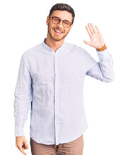 Handsome Young Man With Bear Wearing Elegant Business Shirt And Glasses Waiving Saying Hello Happy And Smiling, Friendly Welcome Gesture