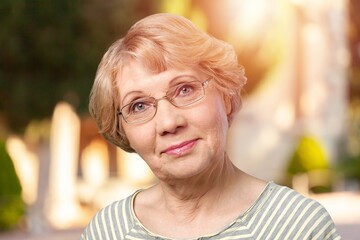 Canvas Print - Beautiful senior old woman posing in park