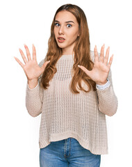 Wall Mural - Young blonde woman wearing casual clothes afraid and terrified with fear expression stop gesture with hands, shouting in shock. panic concept.