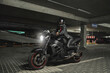 © perfectlab - Young woman biker in a helmet sitting on a motorcycle in the underground parking garage