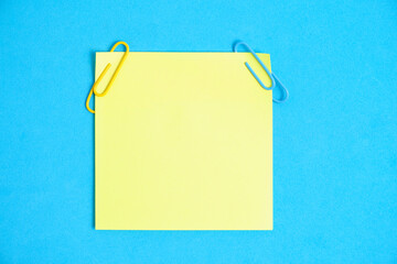 Yellow paper stickers for writing notes on a blue background.