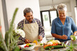 © Laflor/peopleimages.com - Homemade happiness. Shot of a happy senior couple cooking a healthy meal together at home.