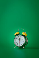 Wall Mural - Retro silver alarm clock.  12:00  am or  pm. Green background.