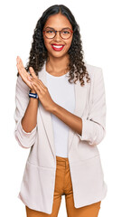 Wall Mural - Young african american girl wearing business clothes clapping and applauding happy and joyful, smiling proud hands together