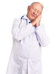 Poster - Senior handsome grey-haired man wearing doctor coat and stethoscope sleeping tired dreaming and posing with hands together while smiling with closed eyes.