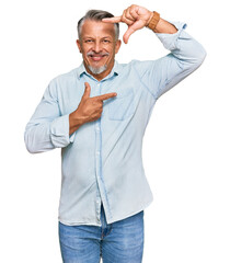 Sticker - Middle age grey-haired man wearing casual clothes smiling making frame with hands and fingers with happy face. creativity and photography concept.