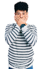 Canvas Print - Young arab man with beard wearing casual striped sweater shocked covering mouth with hands for mistake. secret concept.