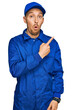 © Krakenimages.com - Bald man with beard wearing builder jumpsuit uniform surprised pointing with finger to the side, open mouth amazed expression.