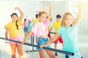 Wall Mural - Young boys and girls training together during group ballet class.