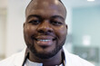 © Wavebreak Media - Portrait of happy african american male doctor with stethoscope in hospital
