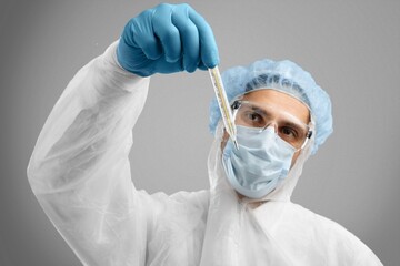 Poster - Young doctor with test tube in hand