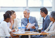 © Yuri A/peopleimages.com - Time to put our plans into action. Shot of a group of businesspeople having a boardroom meeting.