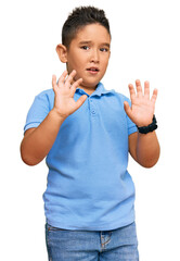 Canvas Print - Little boy hispanic kid wearing casual clothes afraid and terrified with fear expression stop gesture with hands, shouting in shock. panic concept.