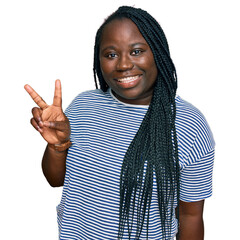 Poster - Young black woman with braids wearing casual clothes showing and pointing up with fingers number two while smiling confident and happy.