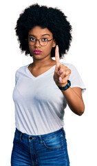 Poster - Young african american woman wearing casual white t shirt pointing with finger up and angry expression, showing no gesture