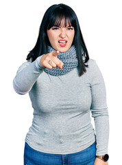 Sticker - Young hispanic plus size woman wearing winter scarf pointing displeased and frustrated to the camera, angry and furious with you