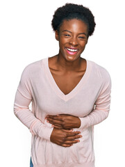 Poster - Young african american girl wearing casual clothes smiling and laughing hard out loud because funny crazy joke with hands on body.