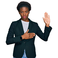 Poster - Young african american girl wearing business clothes swearing with hand on chest and open palm, making a loyalty promise oath