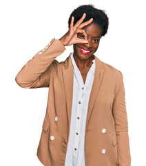 Poster - Young african american girl wearing business clothes smiling happy doing ok sign with hand on eye looking through fingers