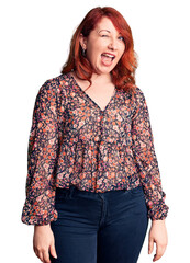 Poster - Young beautiful redhead woman wearing casual t-shirt winking looking at the camera with sexy expression, cheerful and happy face.