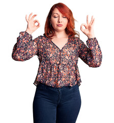 Sticker - Young beautiful redhead woman wearing casual t-shirt relax and smiling with eyes closed doing meditation gesture with fingers. yoga concept.