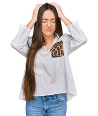 Canvas Print - Young hispanic girl wearing casual clothes suffering from headache desperate and stressed because pain and migraine. hands on head.