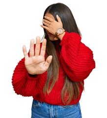 Wall Mural - Beautiful hispanic woman wearing casual clothes covering eyes with hands and doing stop gesture with sad and fear expression. embarrassed and negative concept.