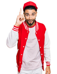 Poster - Young man with beard wearing baseball uniform pointing finger up with successful idea. exited and happy. number one.