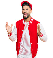 Wall Mural - Young man with beard wearing baseball uniform crazy and mad shouting and yelling with aggressive expression and arms raised. frustration concept.