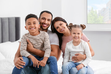 Sticker - Happy international family spending time together on bed at home