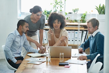 Aufkleber - Failure is no option for this team. Shot of a group of professionals using wireless technology during a meeting.
