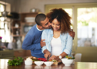 Aufkleber - The healthy marriage is a happy marriage. Shot of a young man kissing his wife while she prepares a healthy meal at home.