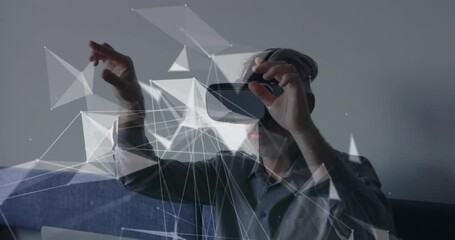 Canvas Print - Animation of connections and data processing over caucasian businessman using vr headset in office