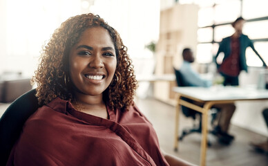 Poster - Where theres confidence theres success. Portrait of a young businesswoman sitting in a modern office with her colleagues working in the background.