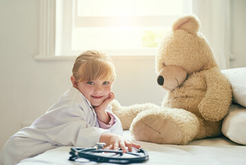 Wall Mural - I ant to help you with your heath. Shot of an adorable little girl dressed up as a doctor and treating her teddy bear as a patient.