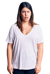 Poster - Young beautiful brunette woman wearing casual t-shirt skeptic and nervous, frowning upset because of problem. negative person.