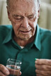 © Viglietti/peopleimages.com - Managing his chronic condition to stay healthy. Cropped shot of a senior man about to take his medication.