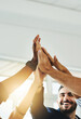 © Delmaine D/peopleimages.com - Motivated more than ever before. Cropped shot of a group of businesspeople high fiving in an office.
