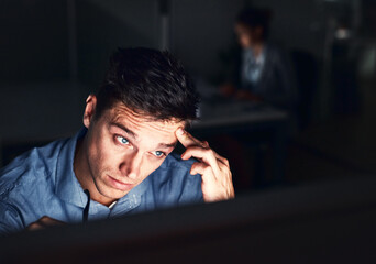Leinwandbilder - Working the late night grind to get the work done. Cropped shot of a young attractive businessman working late in the office.
